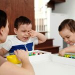 mother looking at her children, 1 is emotional and the 1 is playing